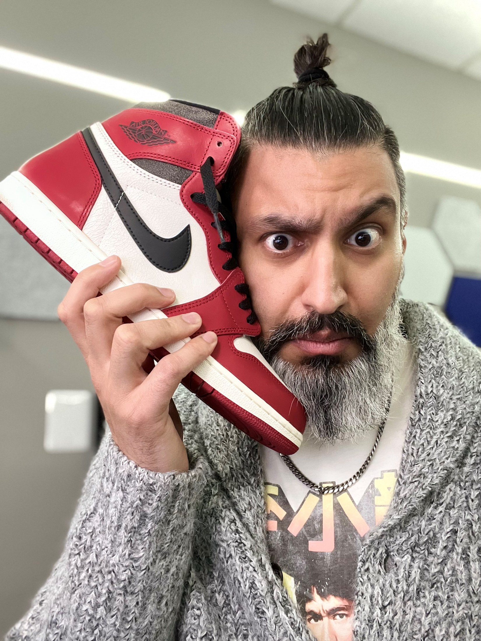 Dr. Sulman Aziz Mirza as TheKicksShrink, holding a sneaker